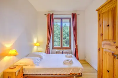 a small bedroom with a bed and a window at Appartement Yodel - Welkeys in Saint-Gervais-les-Bains