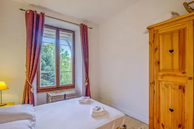 a bedroom with a bed and a window at Appartement Yodel - Welkeys in Saint-Gervais-les-Bains