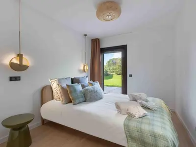a bedroom with a white bed with pillows and a window at Spacieux appartement moderne à Megève, 6 personnes - FR-1-569-129 in Megève