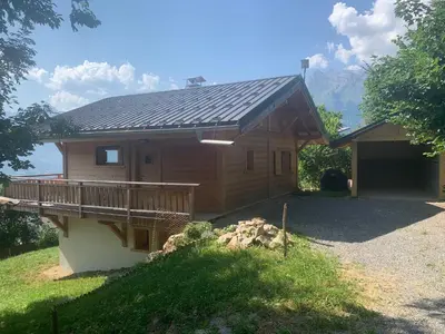 a small house with a porch and a deck at Chalet le jardin de fées in Saint-Gervais-les-Bains