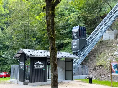 a lift over a building with a tree at Chalet le jardin de fées in Saint-Gervais-les-Bains