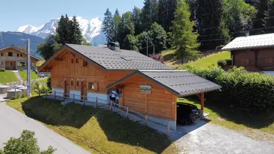a model of a wooden house with mountains in the background at Chalet à Saint-Gervais-les-Bains, 8 personnes, 4 chambres in Saint-Gervais-les-Bains