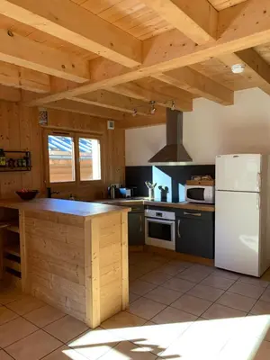 a kitchen with a white refrigerator and a stove at Chalet à Saint-Gervais-les-Bains, 8 personnes, 4 chambres in Saint-Gervais-les-Bains