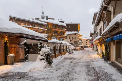 a snow covered street in a town with buildings at Flat - Le Whivern A stone's throw from the village centre in Megève