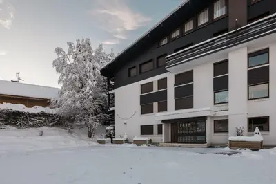 a building with snow on the ground in front of it at Flat - Le Whivern A stone's throw from the village centre in Megève
