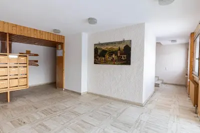 a room with white walls and a painting on the wall at Flat - Le Whivern A stone's throw from the village centre in Megève