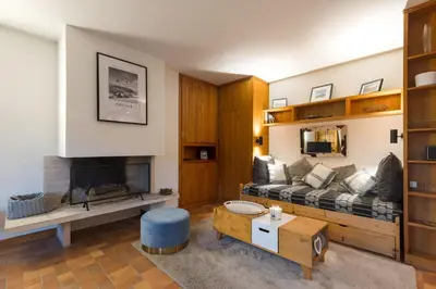 a living room with a couch and a fireplace at Flat - Le Whivern A stone's throw from the village centre in Megève