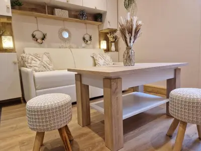 a dining room table with two chairs and a couch at Le Mont Bohème in Saint-Gervais-les-Bains