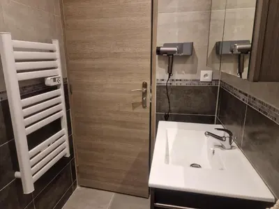 a bathroom with a white sink and a mirror at Le Mont Bohème in Saint-Gervais-les-Bains