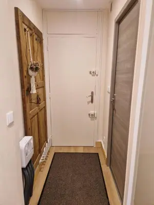 a small hallway with a door and a rug at Le Mont Bohème in Saint-Gervais-les-Bains