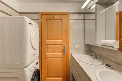 a bathroom with a washing machine and a sink at Apartment Alpes IV - Alpes Travel - Central Chamonix (sleeps 4) in Chamonix-Mont-Blanc