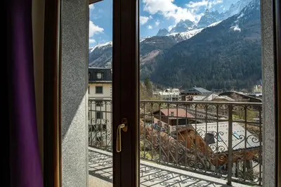a window with a view of a snowy mountain at Apartment Alpes IV - Alpes Travel - Central Chamonix (sleeps 4) in Chamonix-Mont-Blanc