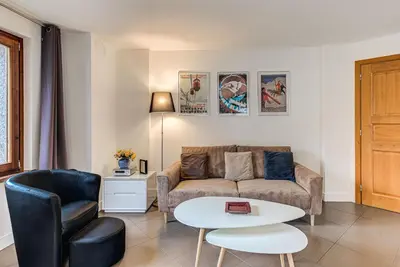 a living room with a couch and a table at Apartment Alpes IV - Alpes Travel - Central Chamonix (sleeps 4) in Chamonix-Mont-Blanc