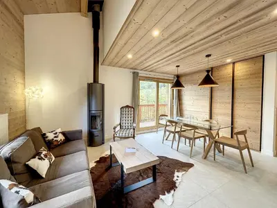 a living room with a couch and a table at Bel appartement 4 pièces près du village, parking inclus - FR-1-560-115 in Combloux