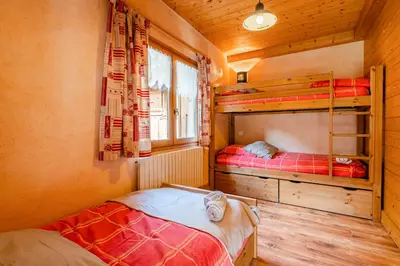 a bedroom with two bunk beds in a cabin at Gîte des Cascades in Sixt