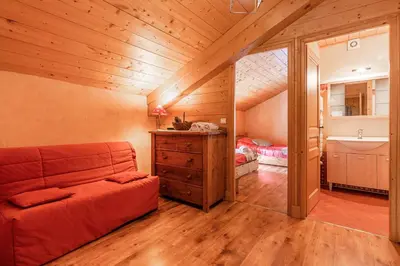 a room with a couch and a sink in a attic at Gîte des Cascades in Sixt