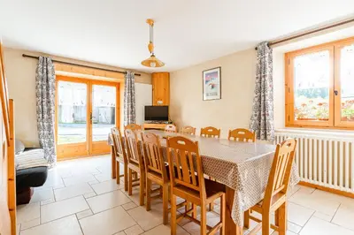 a dining room with a table and chairs at Gîte des Cascades in Sixt