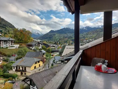 a view from a balcony of a town with mountains at Apartment Les Hauts de Saint Gervais-11 by Interhome in Saint-Gervais-les-Bains