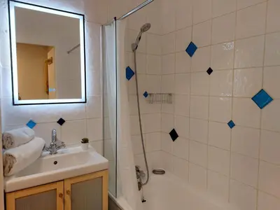 a bathroom with a shower and a sink and a mirror at Apartment Les Hauts de Saint Gervais-11 by Interhome in Saint-Gervais-les-Bains