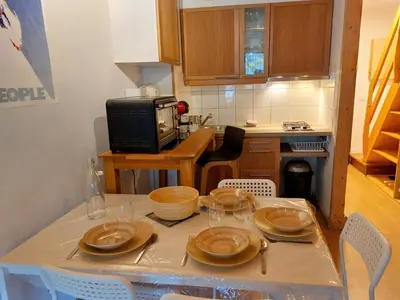 a kitchen with a table with plates on it at Apartment Les Hauts de Saint Gervais-11 by Interhome in Saint-Gervais-les-Bains