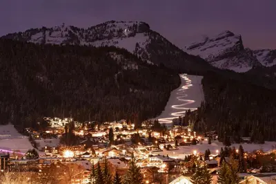 a town in the snow at night with mountains at gc462 studio 4 pers proche skibus in Les Carroz d'Araches