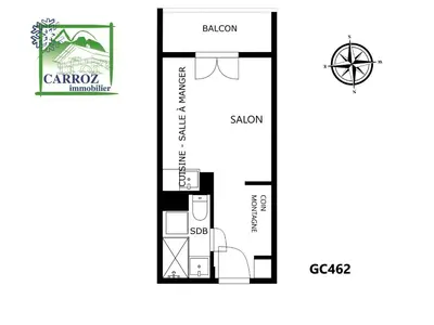 a kitchen with a wooden table and a tv on the wall at gc462 studio 4 pers proche skibus in Les Carroz d'Araches