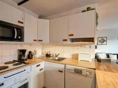 a kitchen with white cabinets and a sink at Appartement lumineux · Centre station · 6 pers · Balcon · WI-FI - FR-1-425-205 in Arâches-la-Frasse