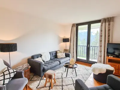 a living room with a couch and a tv at Appartement lumineux · Centre station · 6 pers · Balcon · WI-FI - FR-1-425-205 in Arâches-la-Frasse