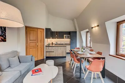 a living room with a couch and a table at Apartment Alpes V - Alpes Travel - Central Chamonix - Sleeps 5 in Chamonix-Mont-Blanc