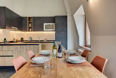 a dining room with a table and chairs and a kitchen at Apartment Alpes V - Alpes Travel - Central Chamonix - Sleeps 5 in Chamonix-Mont-Blanc