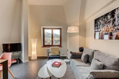 a living room with a couch and a table at Apartment Alpes V - Alpes Travel - Central Chamonix - Sleeps 5 in Chamonix-Mont-Blanc