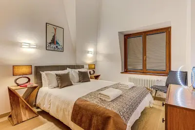a bedroom with a bed and a desk and a window at Apartment Alpes V - Alpes Travel - Central Chamonix - Sleeps 5 in Chamonix-Mont-Blanc