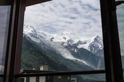 a view of a snow covered mountain from a window at Apartment Alpes V - Alpes Travel - Central Chamonix - Sleeps 5 in Chamonix-Mont-Blanc