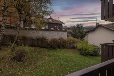a yard with a brick wall and a house at Studio - Le Vorasson Ideal for a duo break in Saint-Gervais! in Saint-Gervais-les-Bains