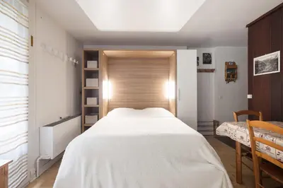 a bedroom with a large white bed and a window at Studio - Le Vorasson Ideal for a duo break in Saint-Gervais! in Saint-Gervais-les-Bains