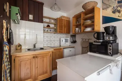 a small kitchen with a sink and a microwave at Studio - Le Vorasson Ideal for a duo break in Saint-Gervais! in Saint-Gervais-les-Bains