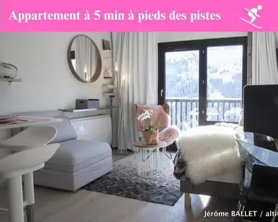 a room with a bed and a chair and a table at NID DOUILLET DE FLAINE in Flaine