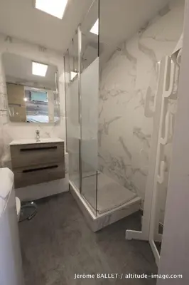 a bathroom with a shower and a sink and a mirror at NID DOUILLET DE FLAINE in Flaine