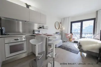 a kitchen with a table and chairs in a room at NID DOUILLET DE FLAINE in Flaine