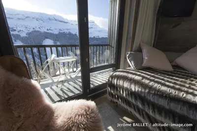a room with a bed and a balcony with a view at NID DOUILLET DE FLAINE in Flaine
