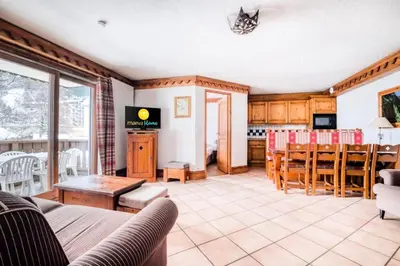 a living room with a couch and a table at Résidence La Ginabelle - maeva Home - Appartement 4 Pièces 8 Personnes - Sélection MAE-7444 in Chamonix-Mont-Blanc