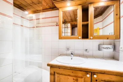 a bathroom with a sink and a shower at Résidence La Ginabelle - maeva Home - Appartement 4 Pièces 8 Personnes - Sélection MAE-7444 in Chamonix-Mont-Blanc