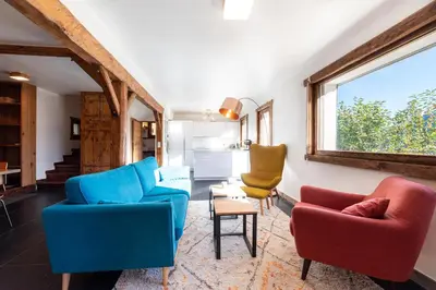 a living room with two chairs and a table at Le Relief - Maison avec magnifique vue montagne aux Bettex in Saint-Gervais-les-Bains