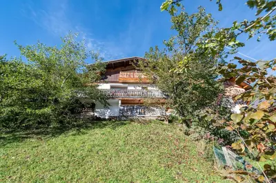 a house on the side of a hill with trees at Le Relief - Maison avec magnifique vue montagne aux Bettex in Saint-Gervais-les-Bains