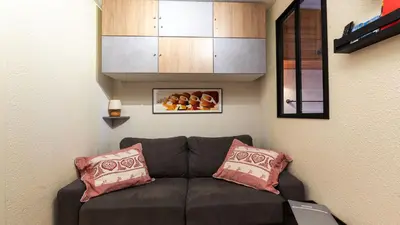 a living room with a brown couch with two pillows at Grande Neige 44 - Appt renove 4 pers in Morillon