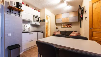 a kitchen and a living room with a table and chairs at Grande Neige 44 - Appt renove 4 pers in Morillon
