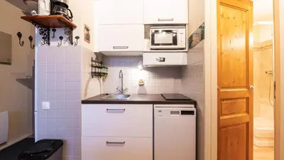 a small kitchen with white cabinets and a sink at Grande Neige 44 - Appt renove 4 pers in Morillon