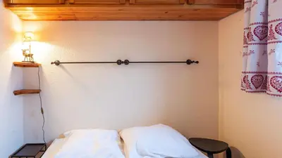 a bed in a room with ainyl at Grande Neige 44 - Appt renove 4 pers in Morillon