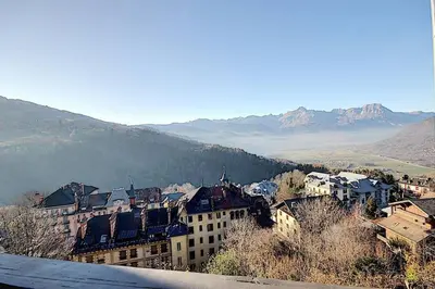 a view of a city with mountains in the background at Les Hauts De Saint Gervais in Saint-Gervais-les-Bains