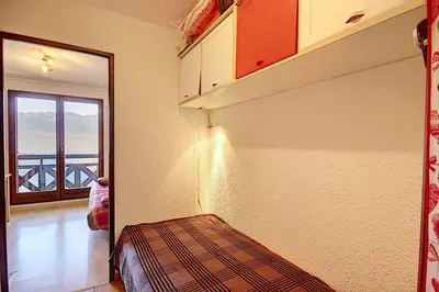 a room with a bed and a view of a balcony at Les Hauts De Saint Gervais in Saint-Gervais-les-Bains